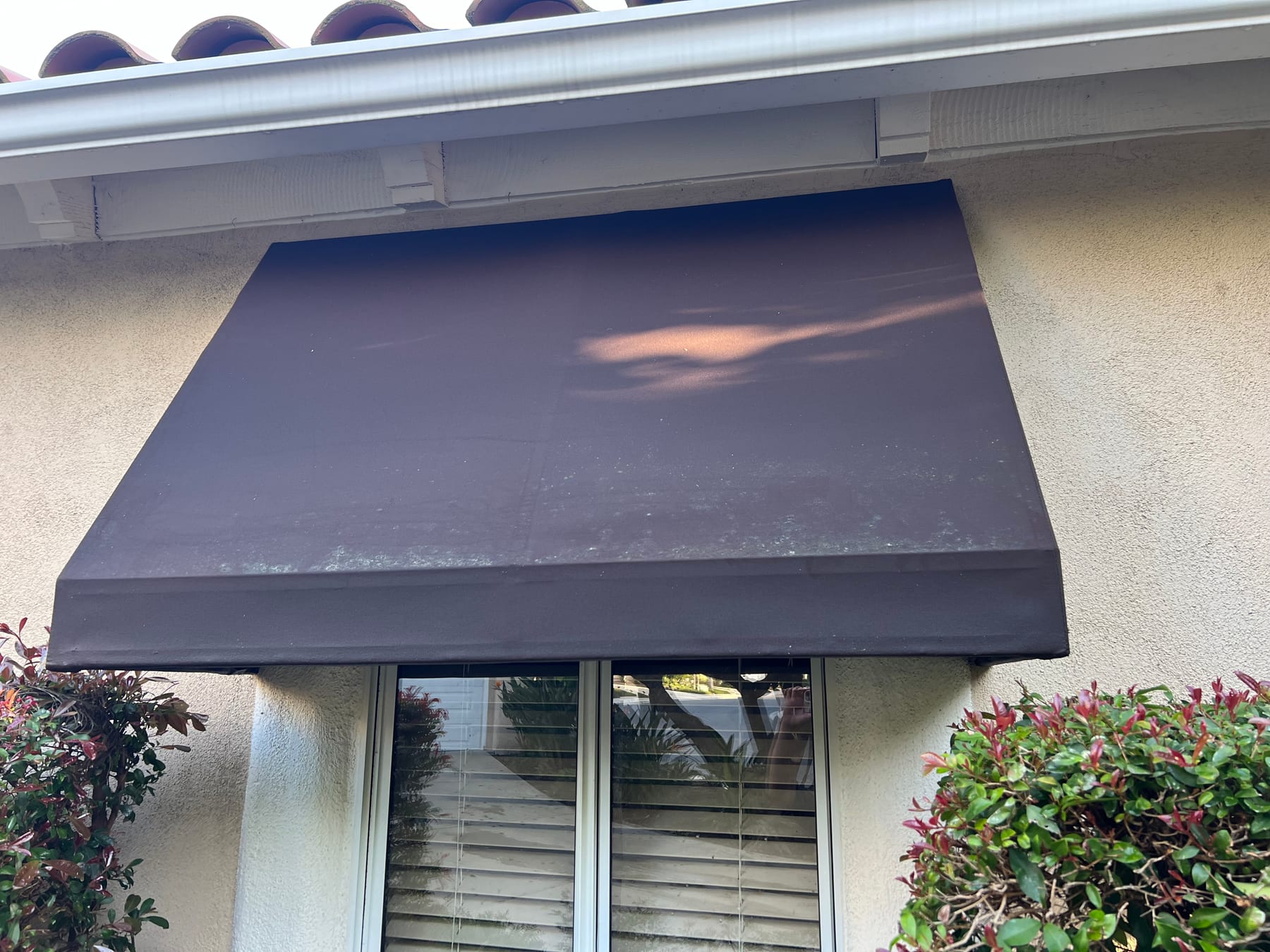 Residential fabric awning after professional exterior cleaning